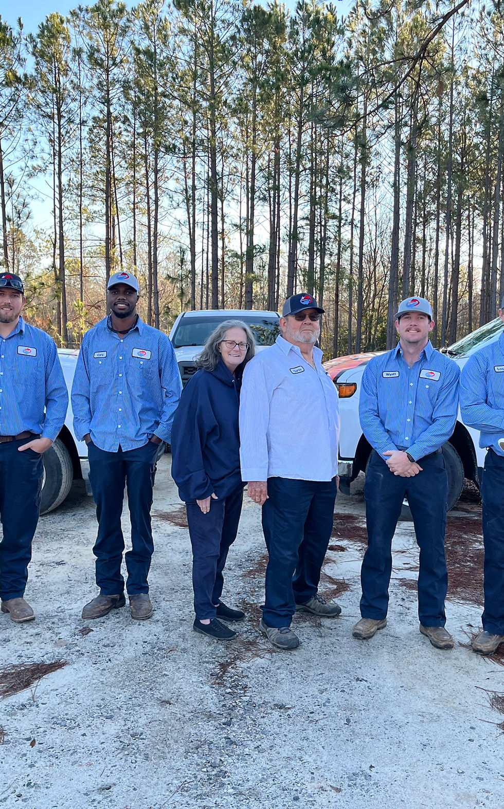 Sweet Georgia Heating and Air team members standing in front of company service trucks in Twin City, Georgia